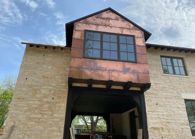 Copper metal panel facade on a stone building for Skylight Installation in Maynard